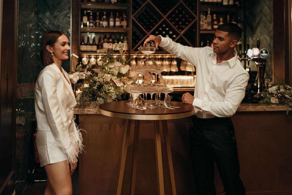 Champagne towers and couple celebrating at SOLE