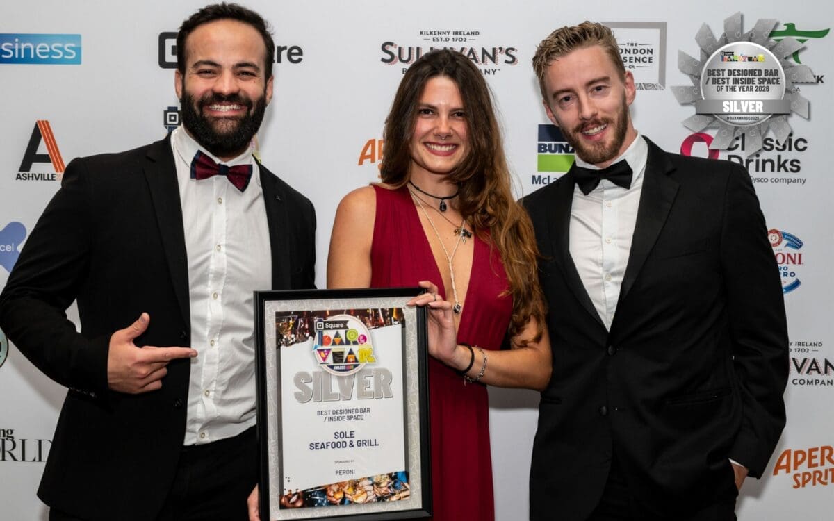 Three of SOLE's team members holding a silver award for best bar design at the Irish Bar of the Year Awards 2026